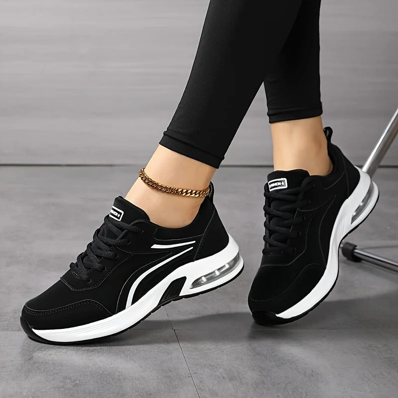 La coppia di sneaker nere con righe e suola bianche